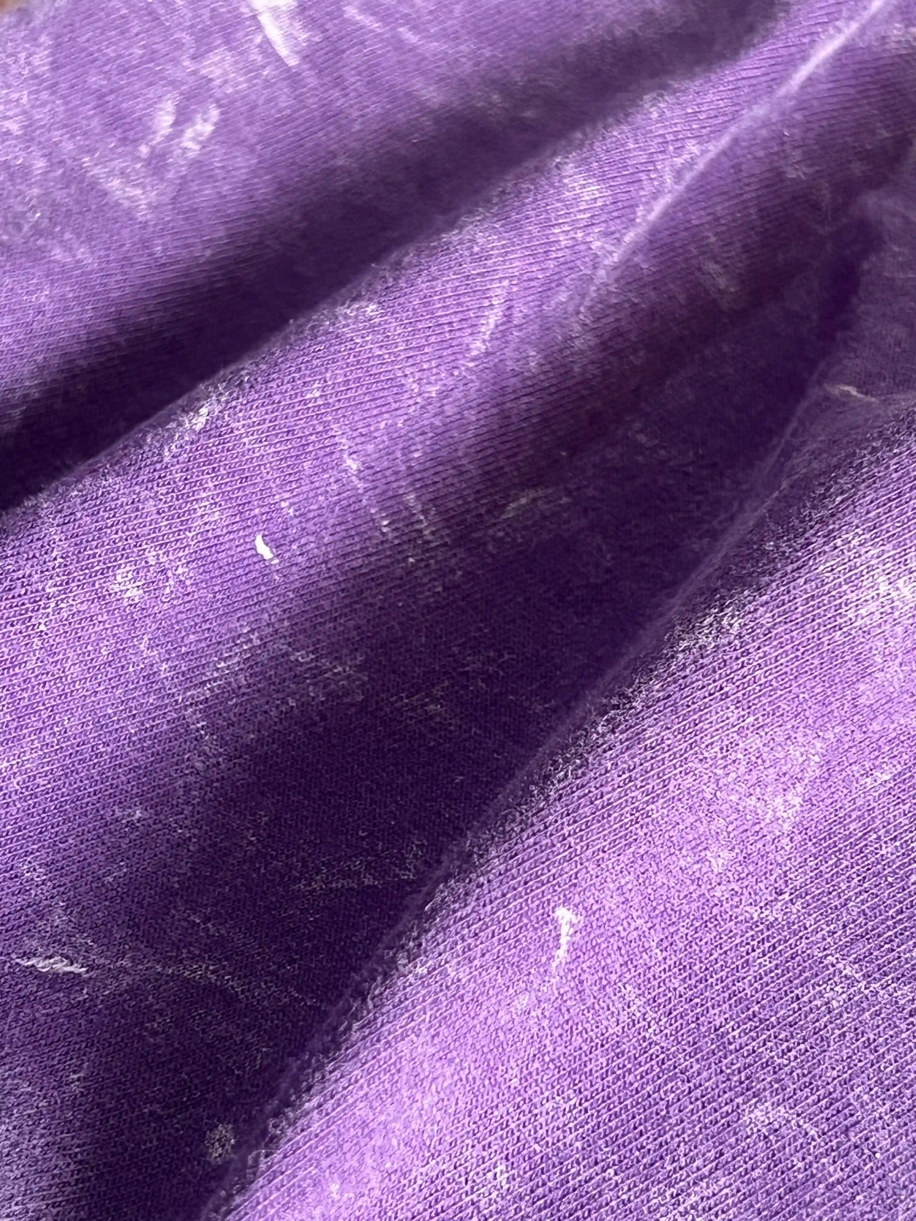 Close-up of fabric texture and print on Amethyst Acid Wash t-shirt – soft cotton with vintage purple finish