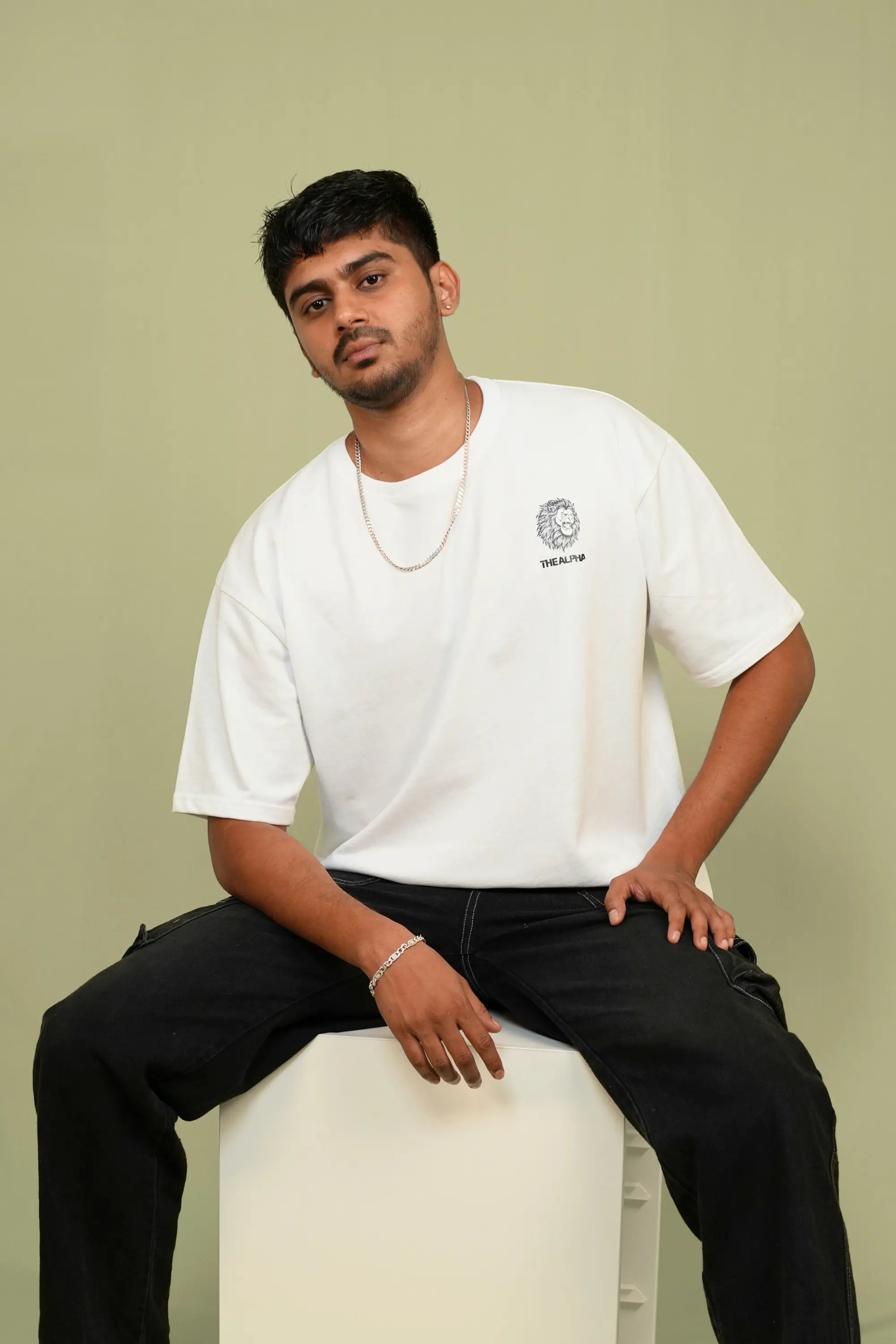 Model wearing Snowbound Alpha white oversized streetwear tee by Cooleo