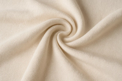 Close-up of beige fabric with a swirl pattern