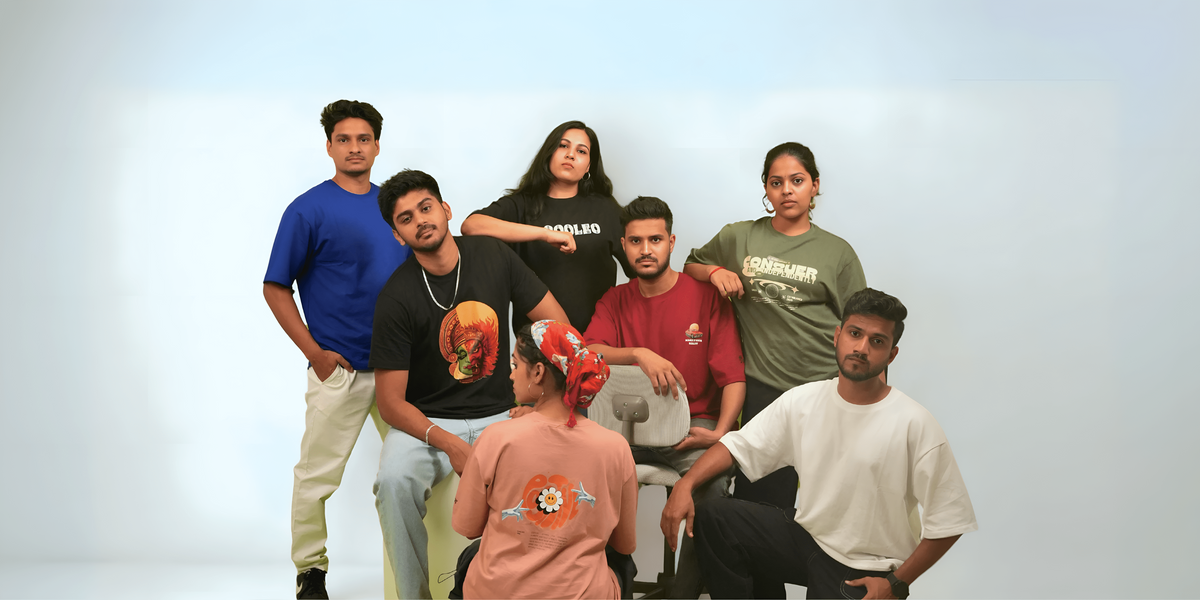 Group of people posing together against a plain background