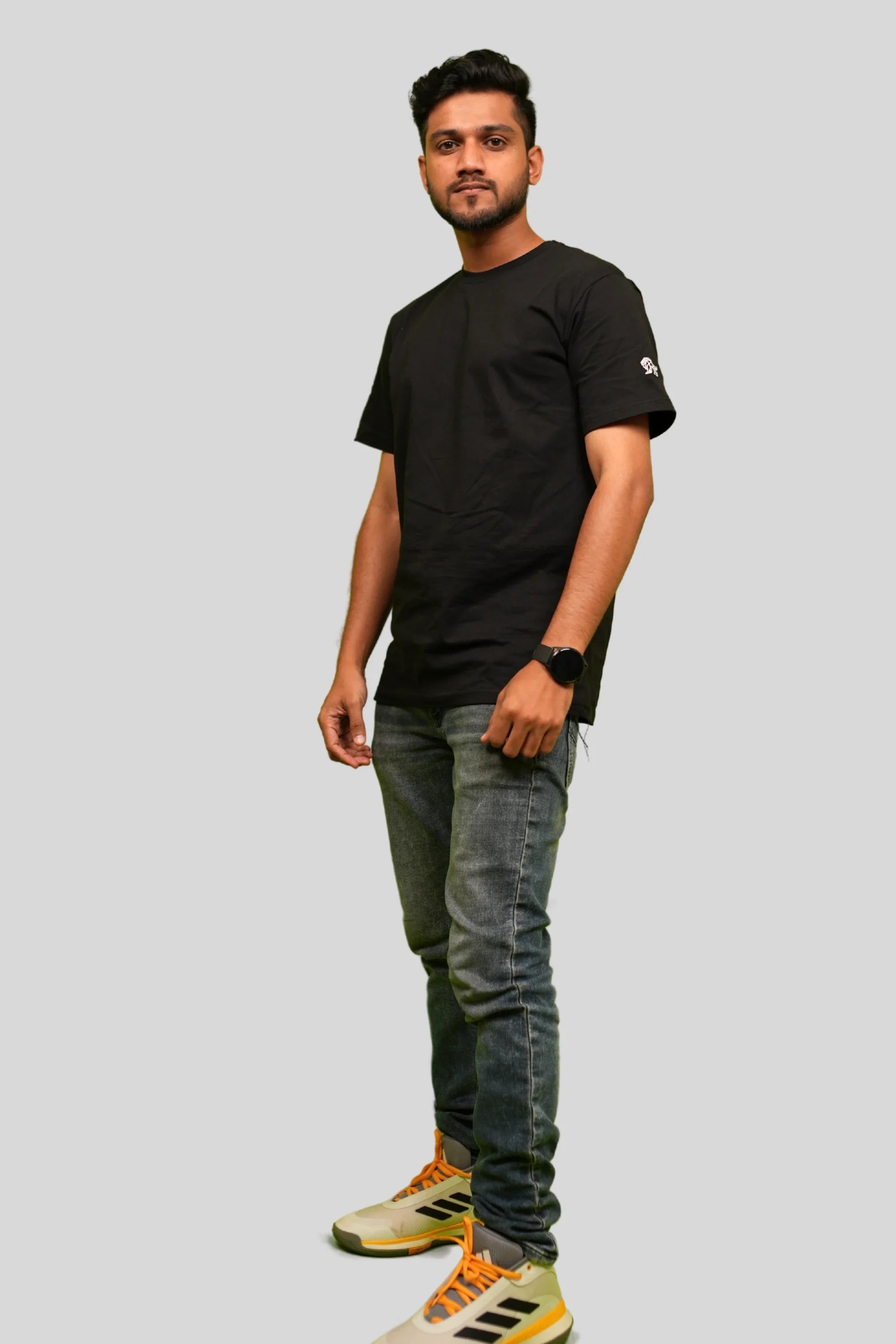 Model wearing Blackstone relaxed black streetwear tee by Cooleo