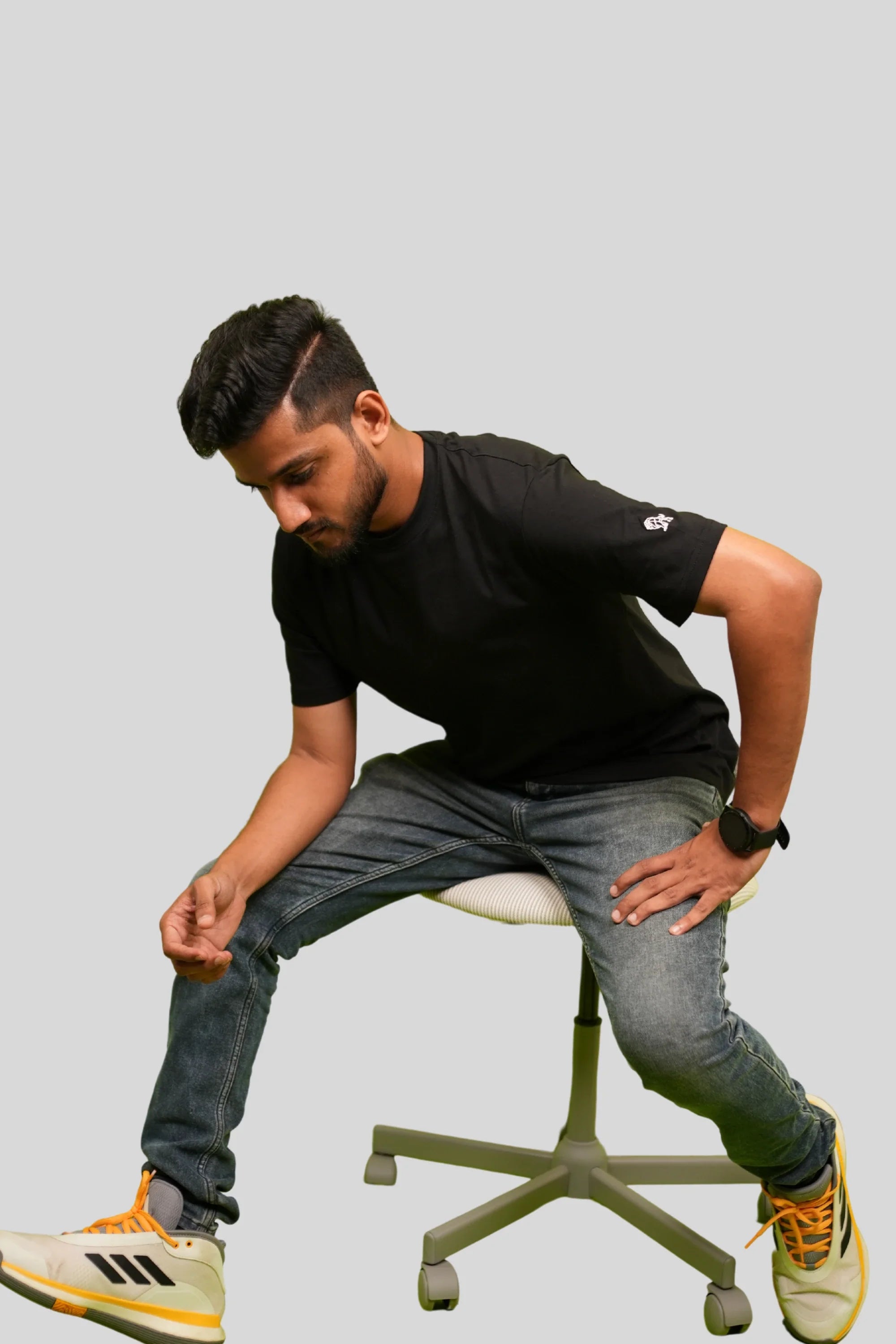 Model wearing Blackstone relaxed black streetwear tee by Cooleo