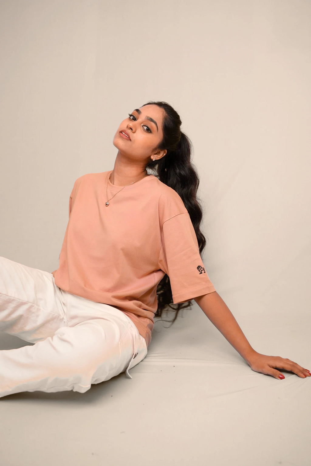 Model wearing Blush Horizon pink oversized tee by Cooleo India