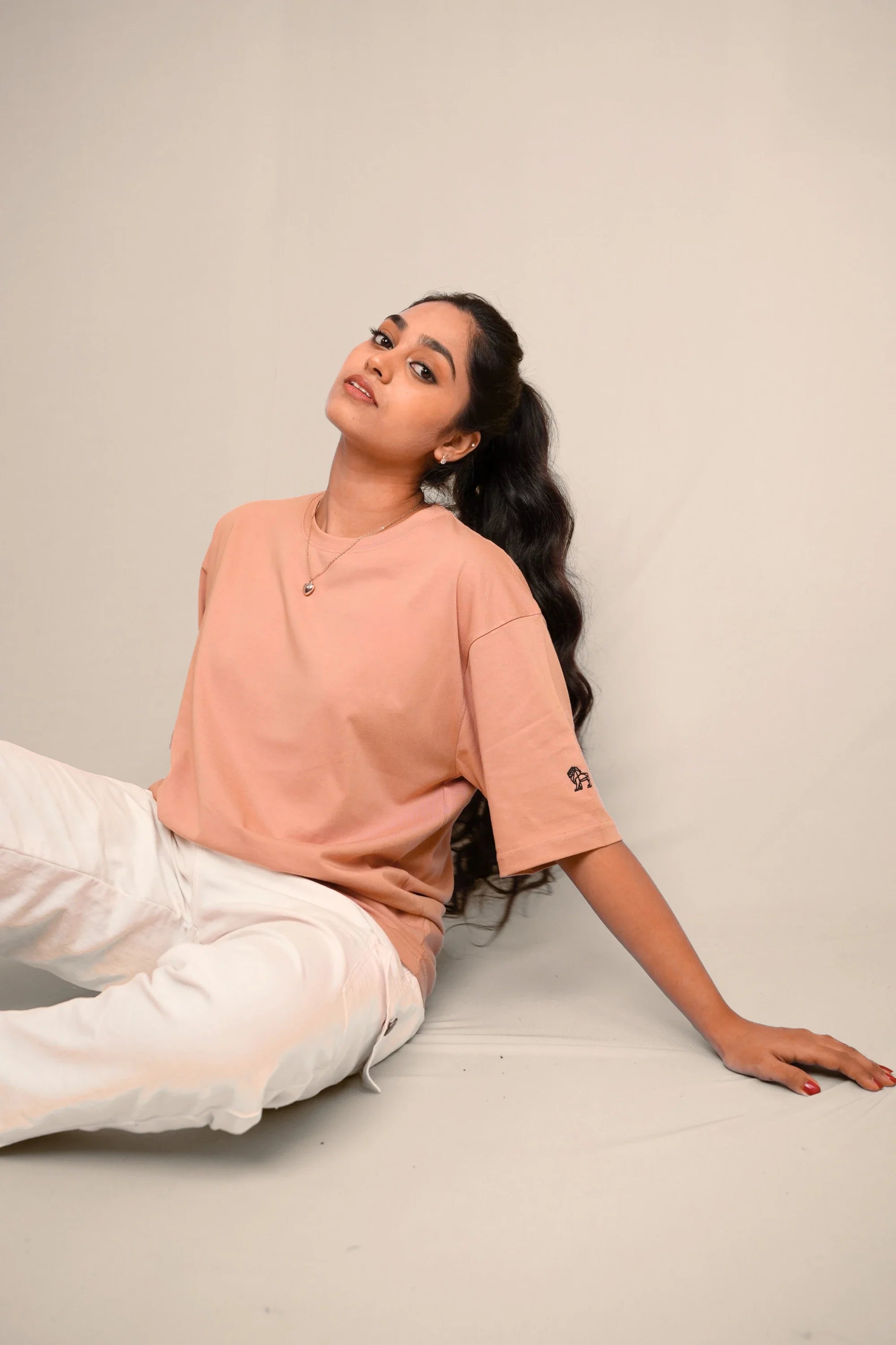 Model wearing Blush Horizon pink oversized tee by Cooleo India